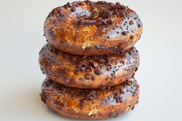 Wall Mural - Stack of chocolate glazed donuts on a white background, showcasing a delicious and indulgent dessert