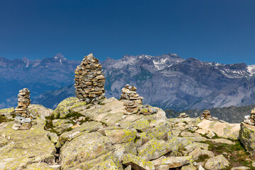 Tour du Montblanc beautiful mountain ladscapes of the Alps green valley, snow summit of Montblanc and rocky peaks of Aiguille du Midi in summer sunny weather blue sky, trekking and hiking in Chamonix