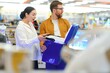© Serhii - A young couple buys a portable refrigerator in an electronics store