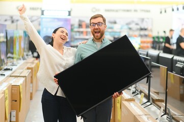 Wall Mural - Couple buying television at store