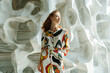 © Jaroon - stylish woman wearing imaginative clothing A backdrop of modern sculpture