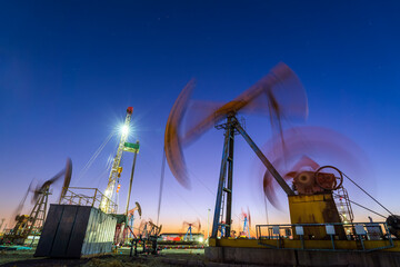 Wall Mural - oil drilling rig in the evening