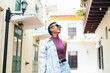 © PEDROMERINO - Portrait of a cool Latin American woman walking in the city