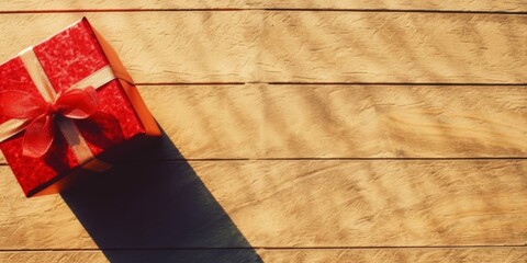 Canvas Print - top view of a bright wooden background with beautiful texture and a red giftbox, copy space, summer sun