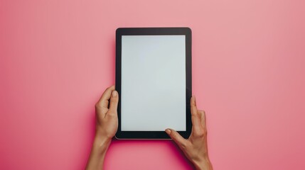 A tablet is held up in front of a colorful wall