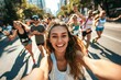 © Snowstudio - a photo of happy woman taking selfie with other people running in marathon