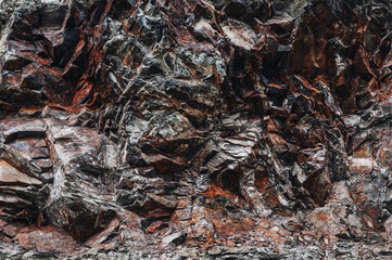 Wall Mural - texture of an orange stone mountain with natural minerals in close-up