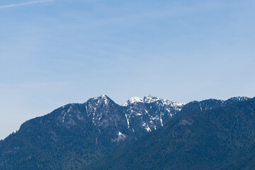 Wall Mural - Beautiful snow-capped mountains against the blue sky with clouds