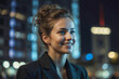 © polack - Woman in a business suit is smiling at the camera in night city