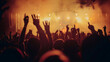 © Gita - A lively crowd with raised hands enjoys a concert, illuminated by warm orange and yellow lights, creating an energetic and vibrant atmosphere.