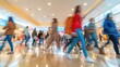 © monvideo - A motion blur image captures the fast-paced energy of young shoppers leaving a sale at a modern mall