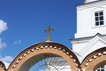 Wall Mural - Golden cross above the entrance arch to the Orthodox church