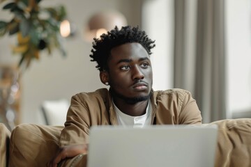 Wall Mural - Person using laptop on sofa