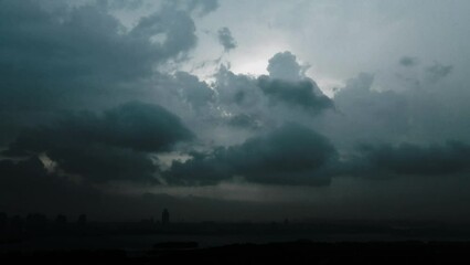 Wall Mural - time lapse of dark clouds over a city