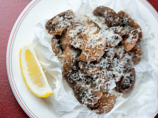 Fried button mushrooms with cheese on a plate	