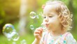 © Paulius - Joyful Moments: Adorable Baby Girl Blowing Soap Bubbles in Spring Park