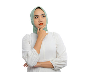 Wall Mural - Pensive young Asian woman in green hijab and white blouse looking aside at empty space and touching chin, thinking, making decision, having doubts isolated on white background