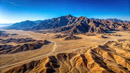 Wall Mural - Aerial view of rugged mountain range in barren desert landscape under a clear sky, mountains, desert, landscape, aerial view, barren, rugged, terrain, nature, wilderness, remote, isolated, arid