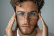 © Sandu - Man in glasses holding head