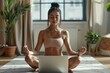 © Sandu - Female in yoga pose using laptop