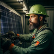 © Dalidudko - A man in a helmet is busy building a solar panel.