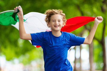 Wall Mural - Child running with Italy flag. Italian fan.