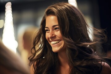 a portrait of a woman with long brown hair, smiling at someone