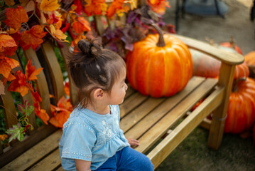 child with pumpkin