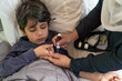 © ADDICTIVE STOCK - Child receives glucose check during hypoglycemia episode by anonymous mother