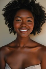 Wall Mural - African American woman smiling, glowing skin, with natural afro hairstyle, wearing minimal makeup, neutral beige background