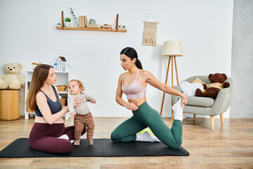 Wall Mural - A young beautiful mother is sitting on a yoga mat, gently holding her baby while receiving guidance from her coach.