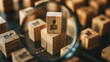 © CozyDigital - Looking for staff. Magnifying glass examines wooden cube with person icon. Careful consideration of candidacy