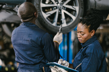 Wall Mural - Mechanic Team Man and Women Staff Working Repair Vehicle in Car Service. Professional Worker Fix Car in Workshop Together.