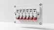 © MP-AI - Close-up of a modern electrical circuit breaker panel with red switches, mounted on a white wall. Industrial safety equipment.