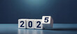© SHOHID Graphics - 2025 number of with change to new era concepts. Flipping the 2024 to 2025 year calendar numbers on white dice, cube blocks isolated on dark blue banner background, minimalist simple style