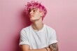 © Dina - young diverse guy non binary person with pink hair wearing blank white t-shirt on pastel pink wall background with copy space