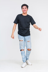 Wall Mural - Young asian man dancing awkwardly in ripped jeans and black shirt