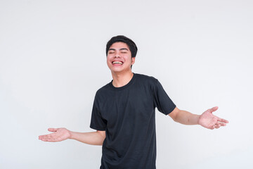 Wall Mural - Carefree young man in black shirt smiling and gesturing not gonna lie or NGL