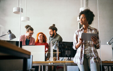 Wall Mural - Portrait of happy success black woman working in a busy modern workplace, Startup coworker concept