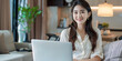 © Di Studio - beautiful asian woman using laptop in modern living room at home