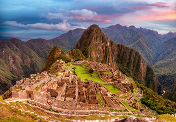 View of the lost inca city Machu Picchu, agriculture terraces at sunset. Peru