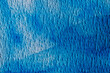 © romantiche - close up of  textured watercolor paper painted in blue color