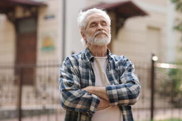 Wall Mural - Portrait of happy grandpa with grey hair outdoors