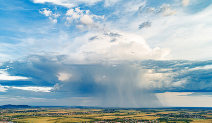Wall Mural - Rain cloud and horizon line. Drone photo.