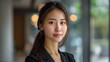 © Антон Сальников - Beautiful Chinese woman, age 30, standing in an office with a confident smile on her face