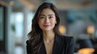 © James - Portrait of filipina woman beautiful business leader, in modern bright office boardroom, professional atmosphere, leadership, diverse workplace, corporate setting.