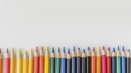 Wall Mural - A row of pencils of different colors are lined up on a white background