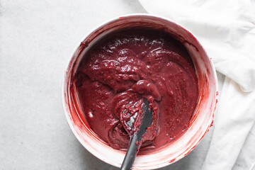 Sticker - Overhead view of red velvet brownie batter in mixing bowl, overhead view of red velvet fudge brownie batter in a ceramic bowl