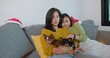 © HarryKiiM Stock - Happy Loving Asian lesbian couple lgbt smiling embracing together while sitting on the couch at home. couple holding petting cute chihuahua dog relaxing on sofa. lgbt relationship pet love