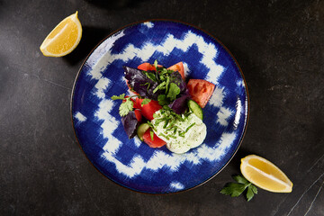 Wall Mural - Fresh Eastern Salad with Vegetables, Basil, and Sour Cream on a Patterned Plate